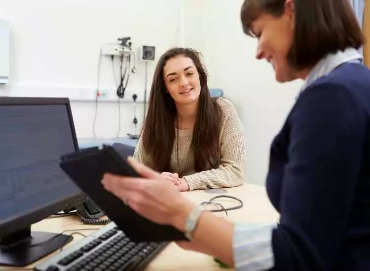 Two female health expert looking at a tablet